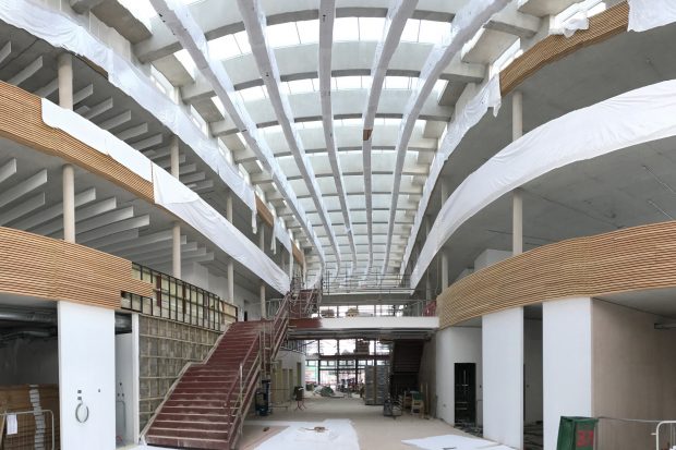 Showing the inside of the UK Hydrographic Office's new building, with an open plan area and three floors