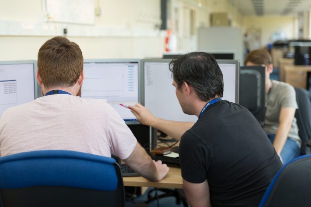 Two software developers working together at a computer