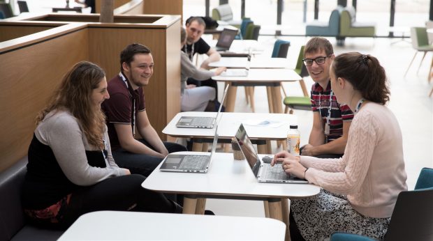 UKHO employees with their laptops in an informal 'coffee and code' meeting