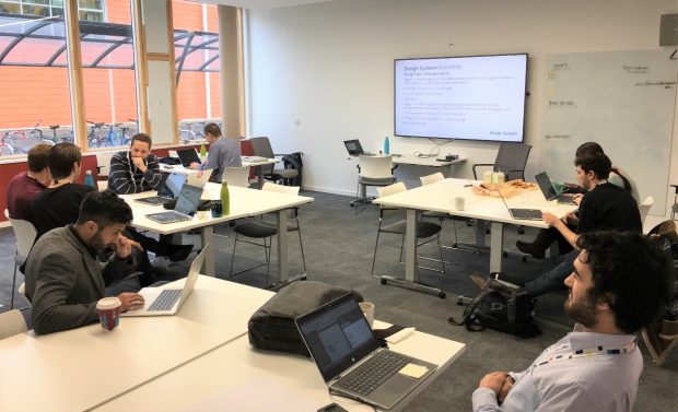 Staff on laptops during a hackathon