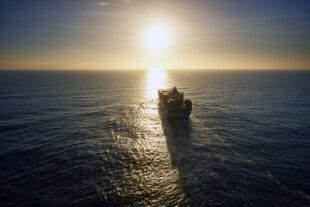 Sunset view of a large vessel in open water