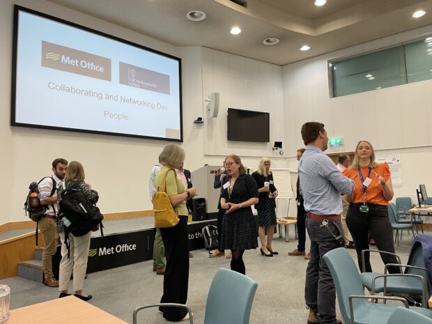 UKHO and Met Office staff talking at event